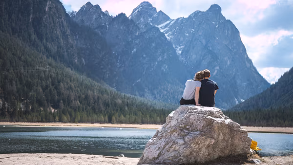 Couple sitting together on a boulder