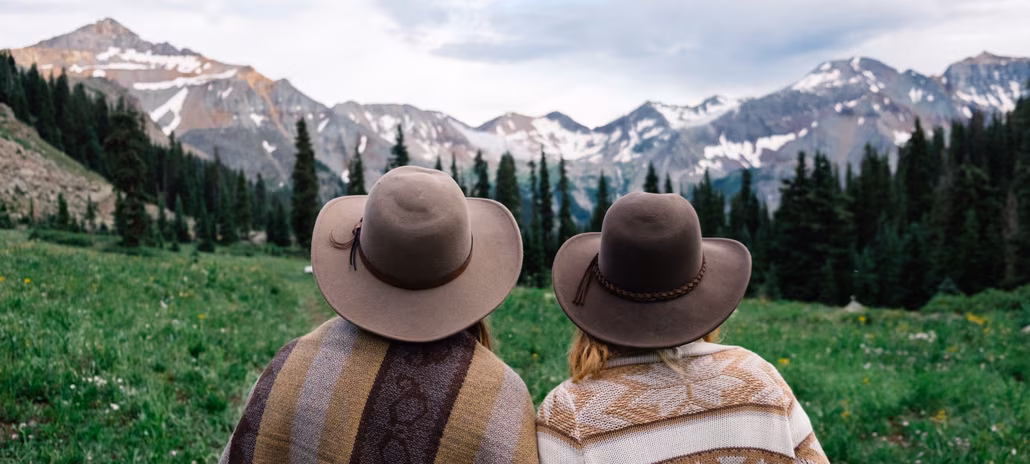Couple sitting overlooking mountain range